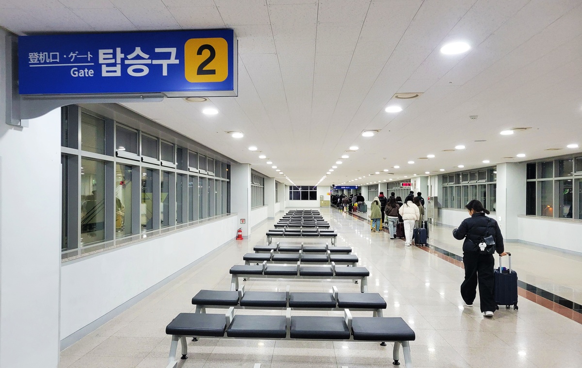 Passengers disembarking from the ferry and walking toward immigration at Busan International Port Terminal