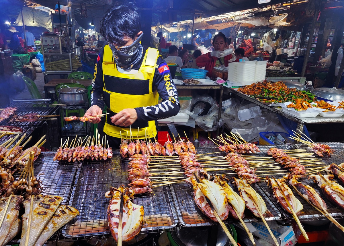 Fresh grilled squid prepared at Kep's Crab Market, a popular street food in Cambodia