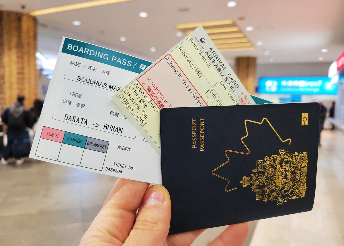Camellia Line ferry ticket (Hakata - Busan), arrival card, and passport in hand