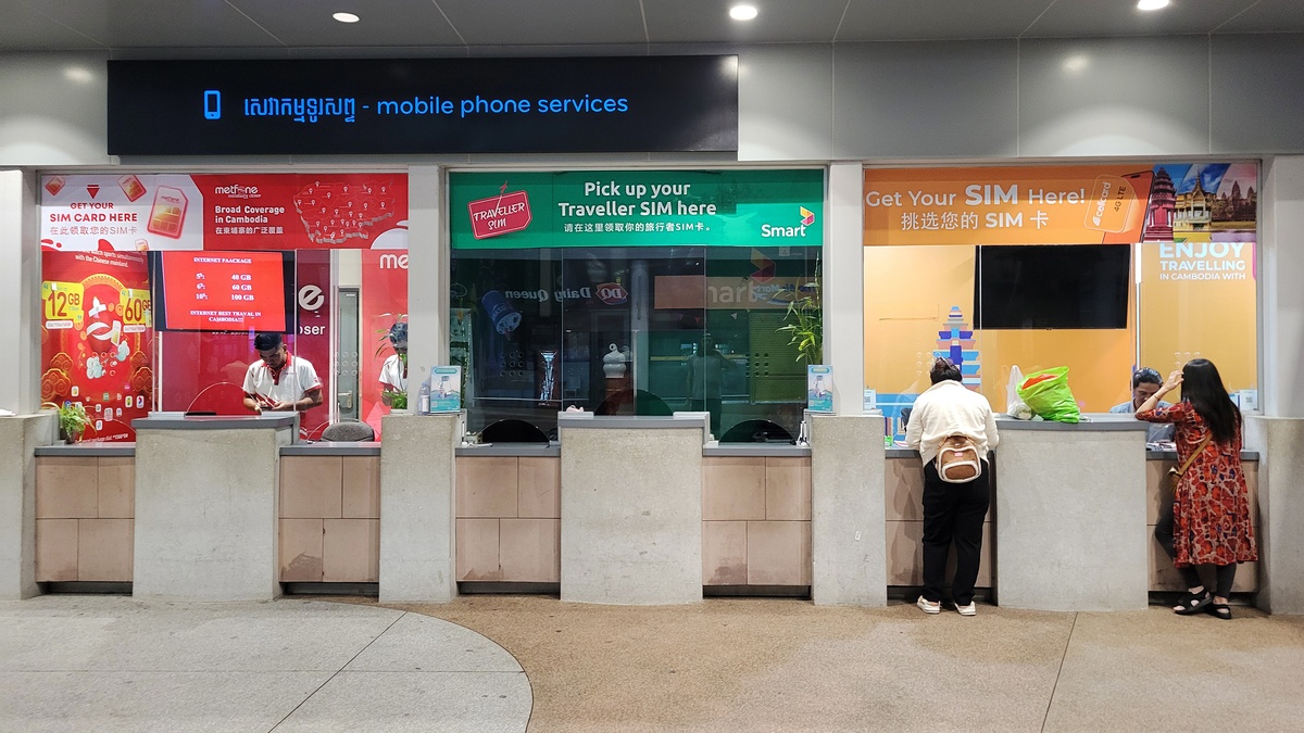 Mobile operator kiosks Smart, Metfone, and Cellcard at Phnom Penh Airport, Cambodia